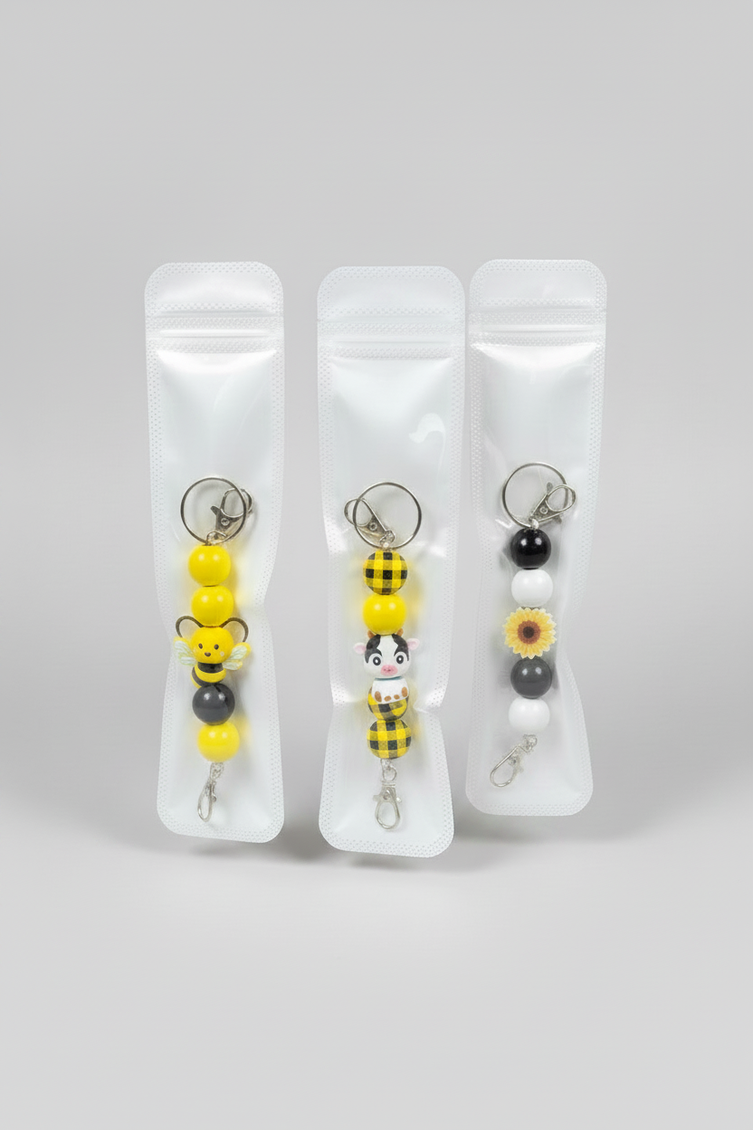 Add a little charm to your everyday essentials with our handmade beaded keychains! Each keychain is carefully handcrafted using high-quality silicone beads and features a fun, unique design that’s perfect for expressing your personality.

Attach it to your keys, purse, backpack, diaper bag, or tote for a cute and stylish accessory that stands out wherever you go.

Features:

🐝 Handmade with premium silicone beads
🔑 Durable keyring and lobster clasp
🎒 Perfect for keys, purses, backpacks, and tote bags
💛 