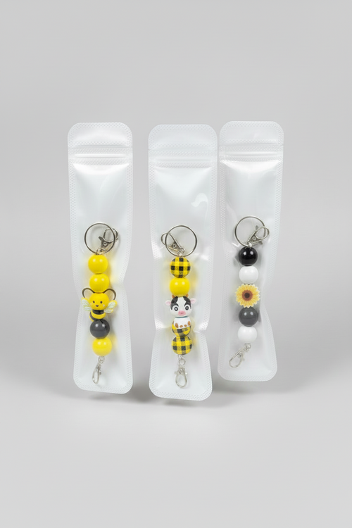 Add a little charm to your everyday essentials with our handmade beaded keychains! Each keychain is carefully handcrafted using high-quality silicone beads and features a fun, unique design that’s perfect for expressing your personality.

Attach it to your keys, purse, backpack, diaper bag, or tote for a cute and stylish accessory that stands out wherever you go.

Features:

🐝 Handmade with premium silicone beads
🔑 Durable keyring and lobster clasp
🎒 Perfect for keys, purses, backpacks, and tote bags
💛 